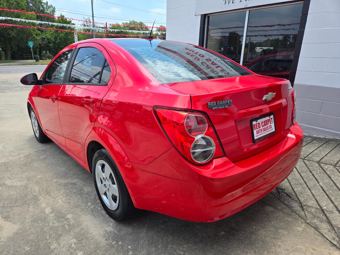 2015 Red /Black Chevrolet Sonic LS Auto Sedan (1G1JA5SH9F4) with an 1.8L L4 DOHC 24V engine, 6-Speed Automatic transmission, located at 503 West Court, Seguin, TX, 78155, (830) 379-3373, 29.568621, -97.969803 - Photo#3